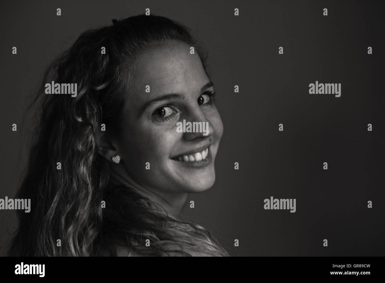 Monochrome Portrait Of A Pretty Young Woman With Wavy Hair Stock Photo