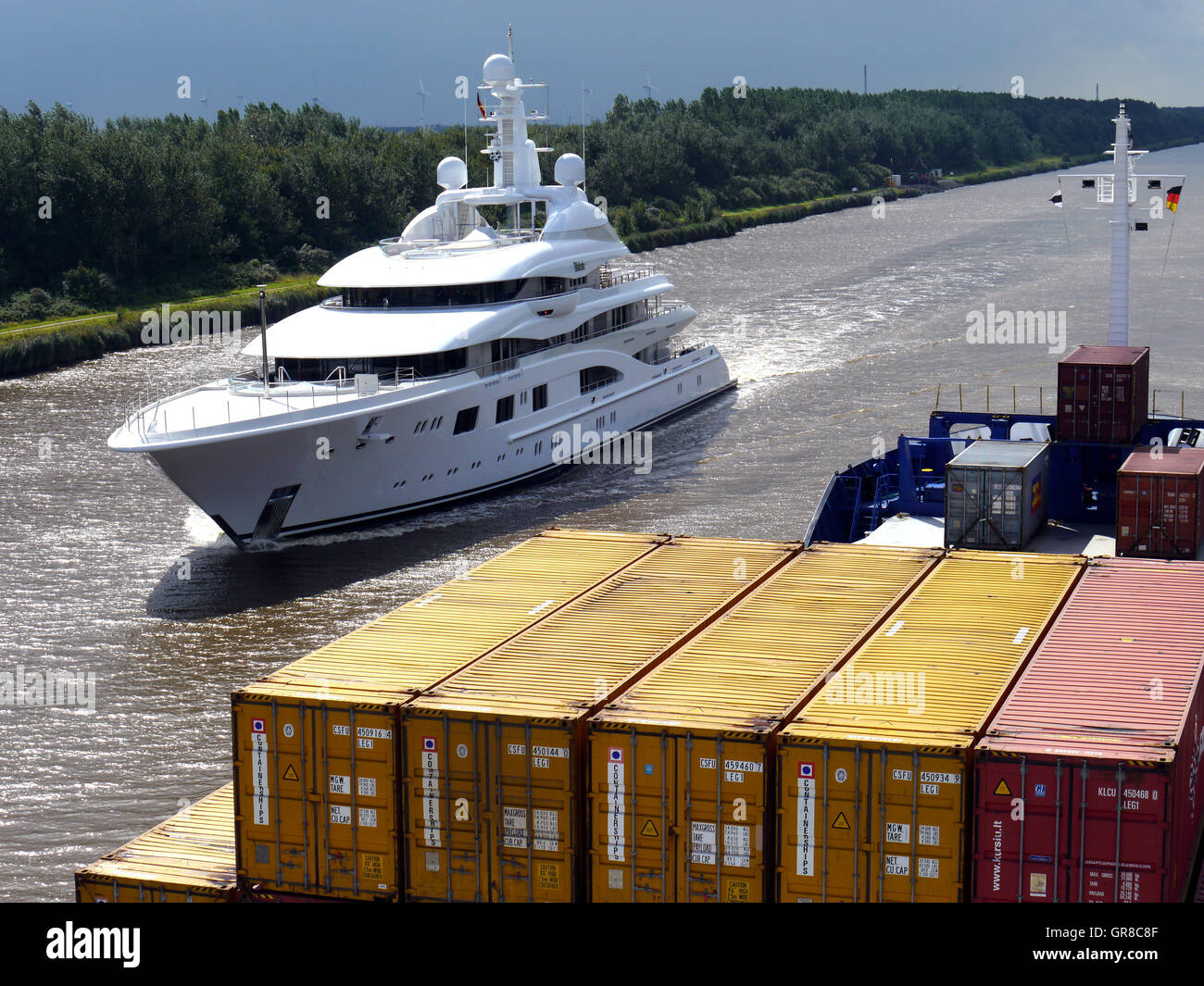 Container Ship Meets Luxury Yacht In The Kiel Canal Stock Photo
