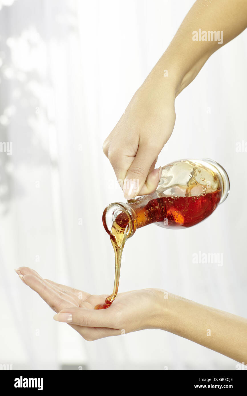 Hands With A Bottle Massage Oil Stock Photo