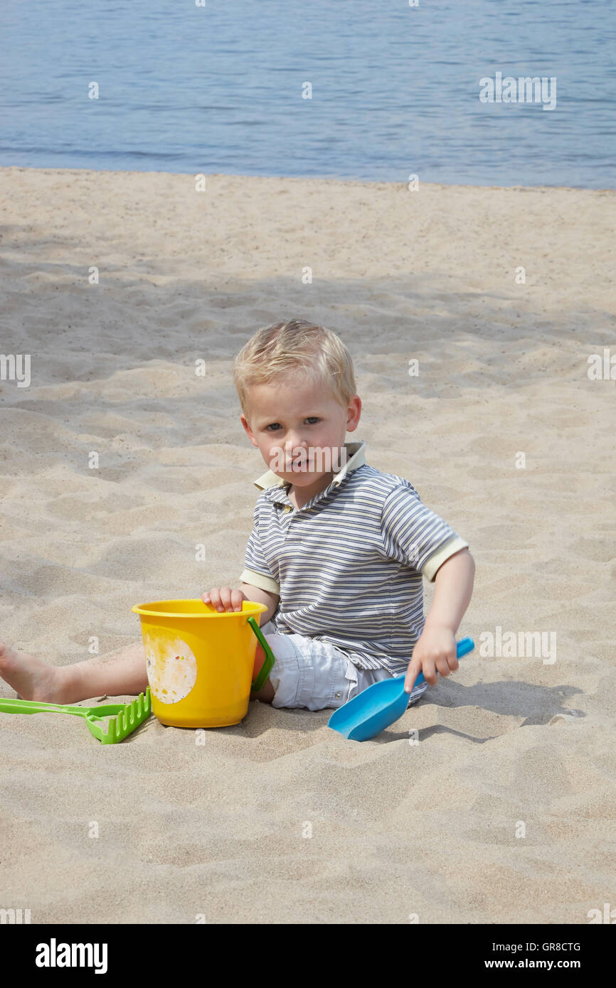 A Young Boy Playing On The Beach Stock Photo