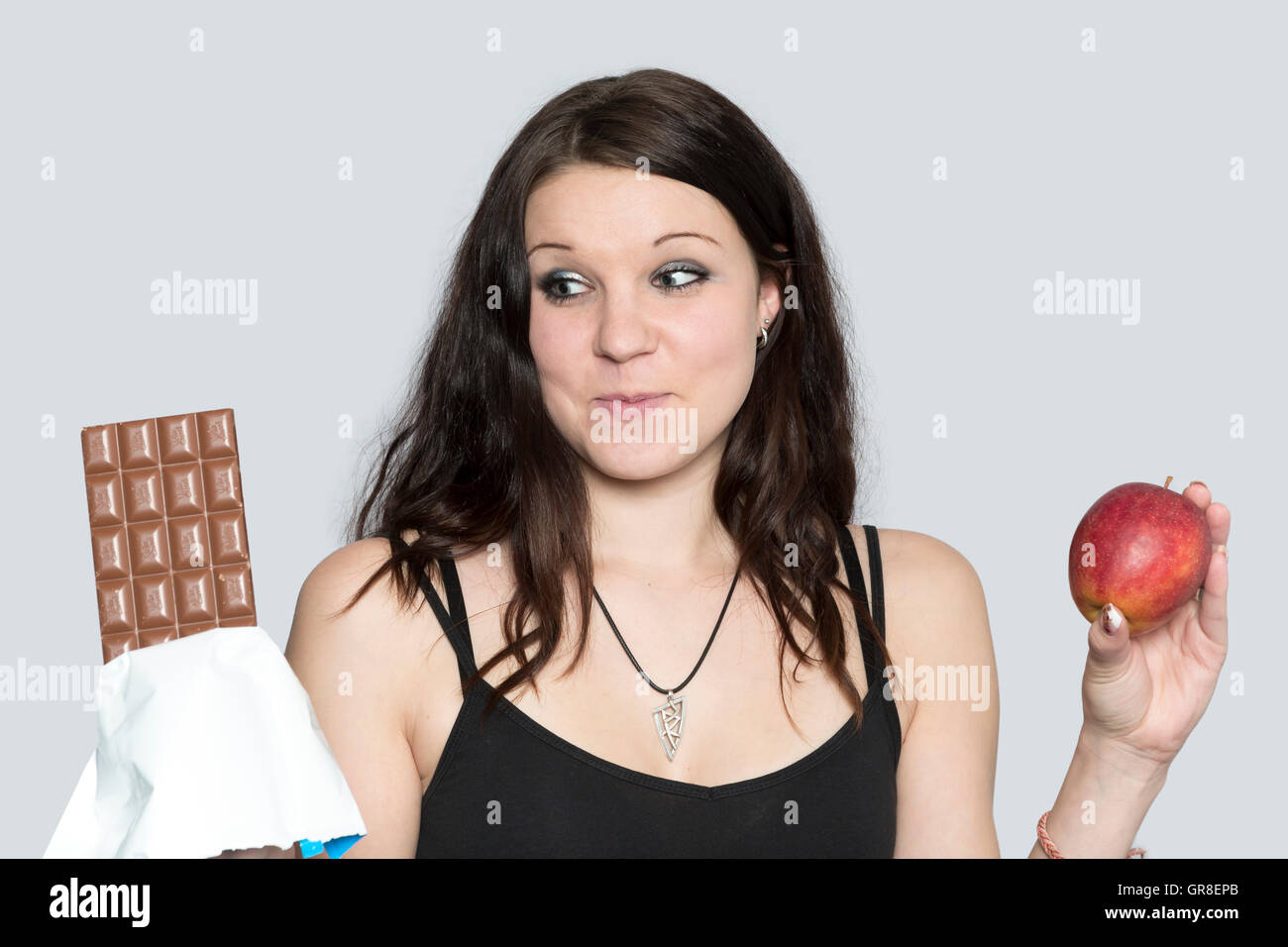 Young Woman Can Not Resist Her Cravings For Sweets Stock Photo