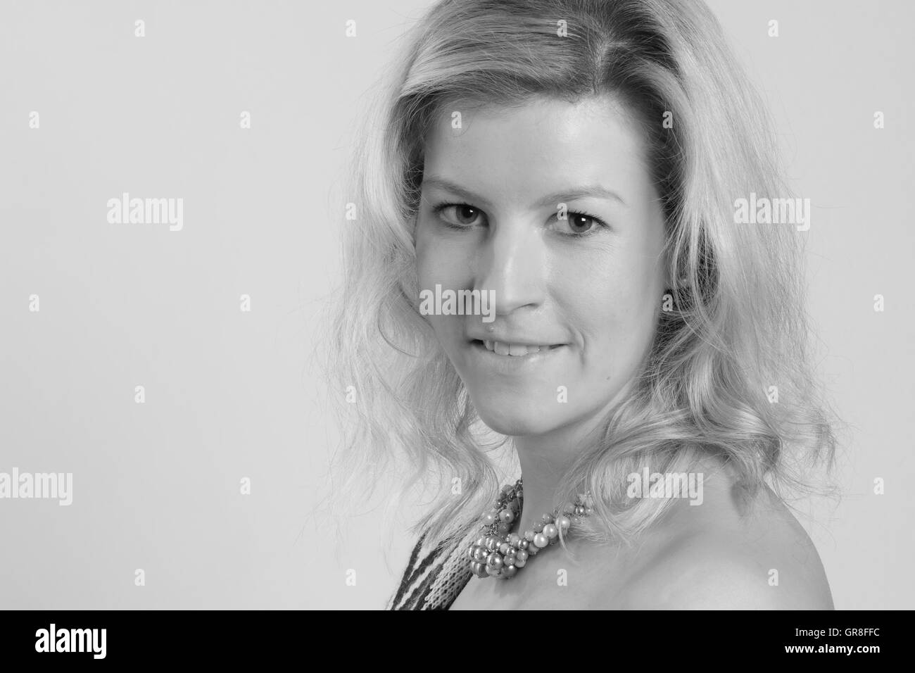 Portrait Shot Of A Young Woman With Long Blond Hair Stock Photo