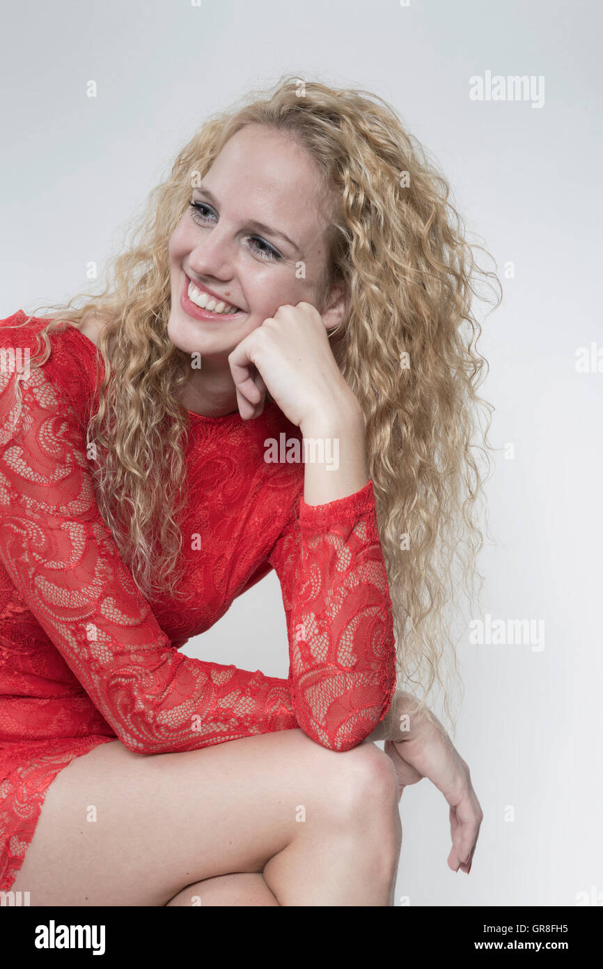 Hearty Laugh Of A Pretty Young Woman In Red Cocktail Dress Stock Photo