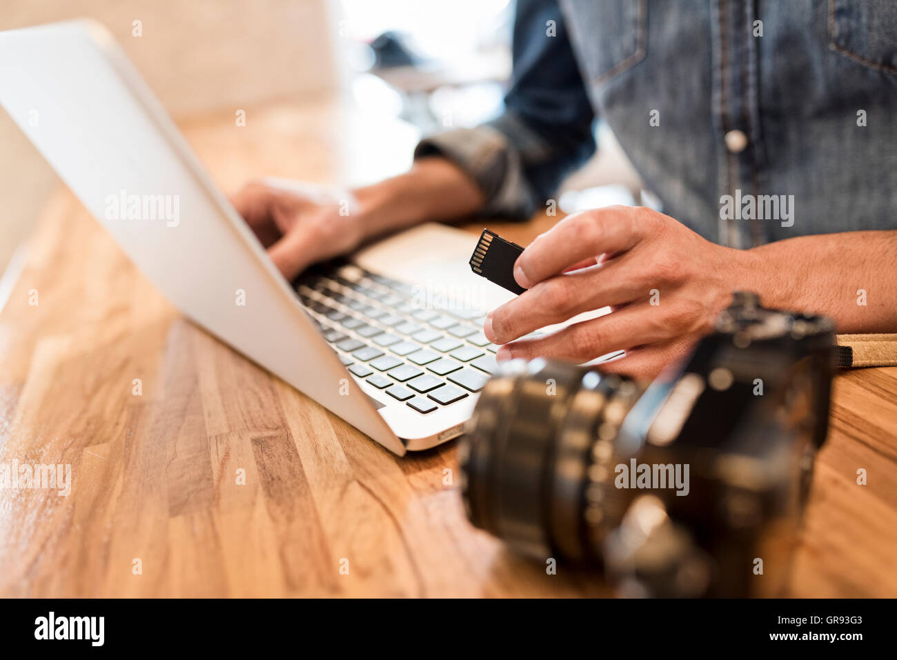 Photographer checking his digital pictures on laptop indoors Stock ...