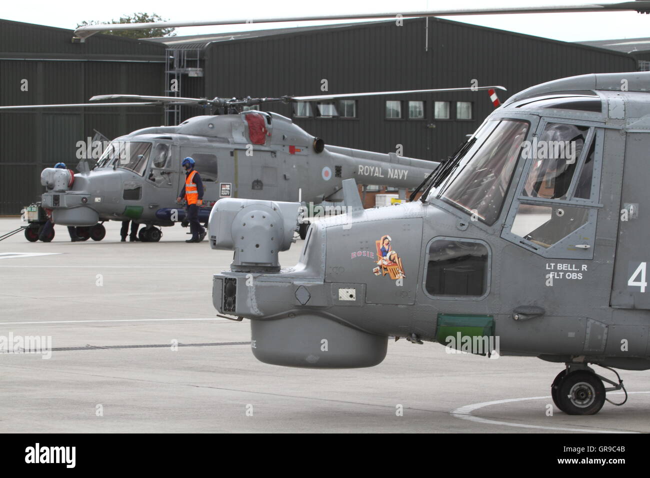 A pair of British built Royal Navy Westland Lynx HMA.8 helicopters on the dispersal / ramp at Royal Naval Air Station Yeovilton Stock Photo
