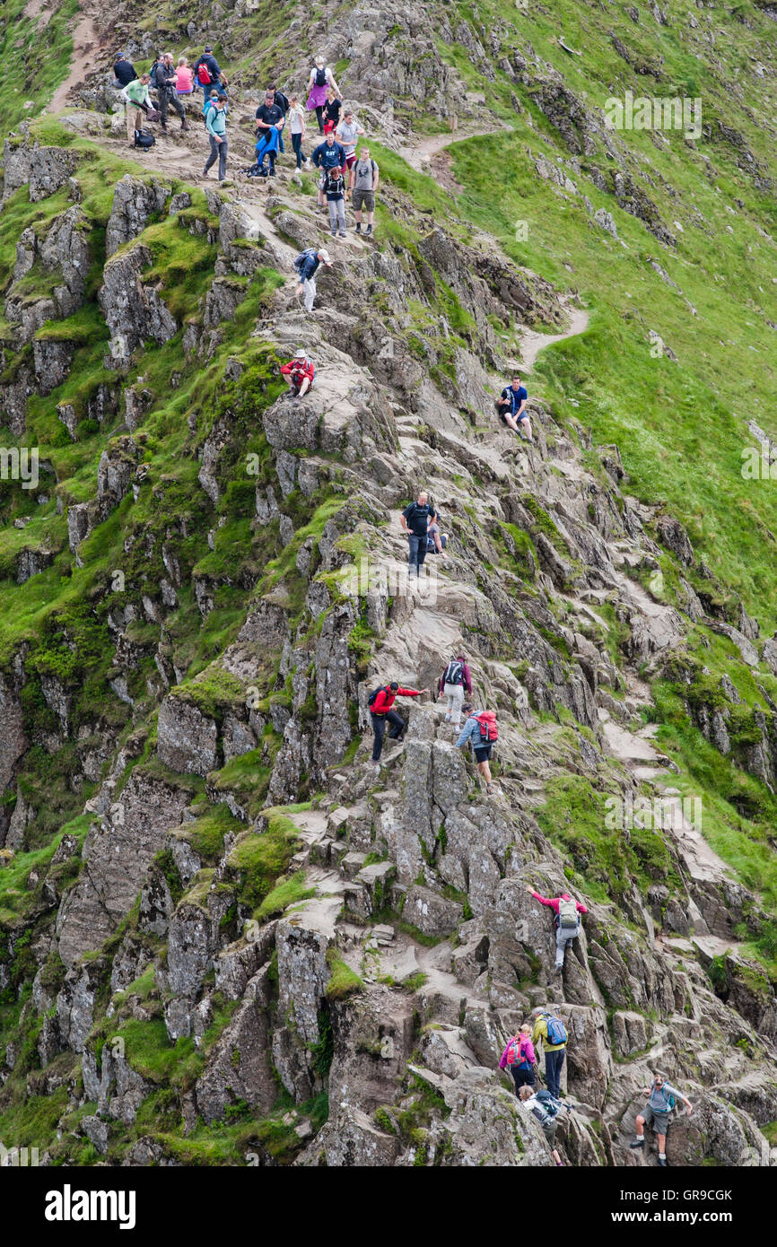 People walking on Striding Edge, Helvellyn, Lake District, Cumbria, England, United Kingdom Stock Photo