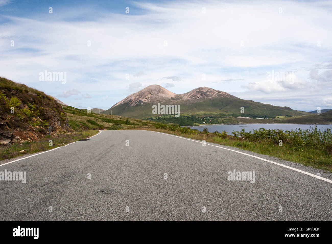 Empty single track road (B8083) with hills of Beinn Dearg Mhor and Beinn Dearg Bheag behind, Strathaird, Isle of Skye, Scotland, Stock Photo