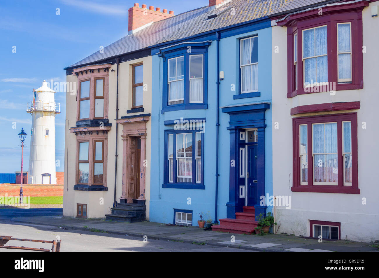 Heugh Battery lighthouse and Victorian terraced houses, The Headland, Hartlepool, County Durham, England Stock Photo