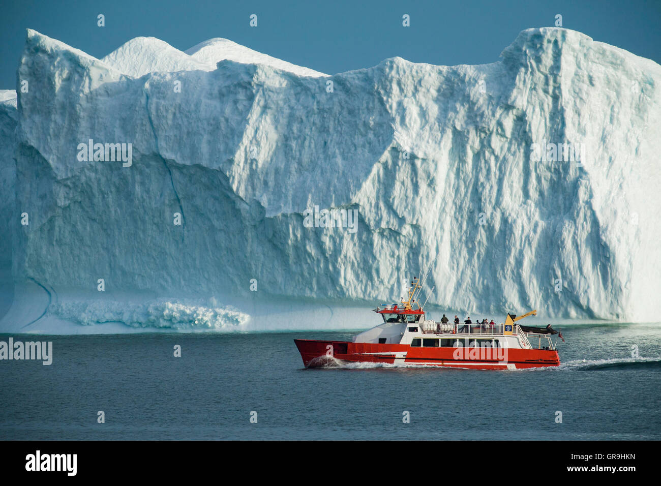 Disko Line ferry passing iceberg, Qeqertarsuaq, Disko Bay, Greenland Stock Photo