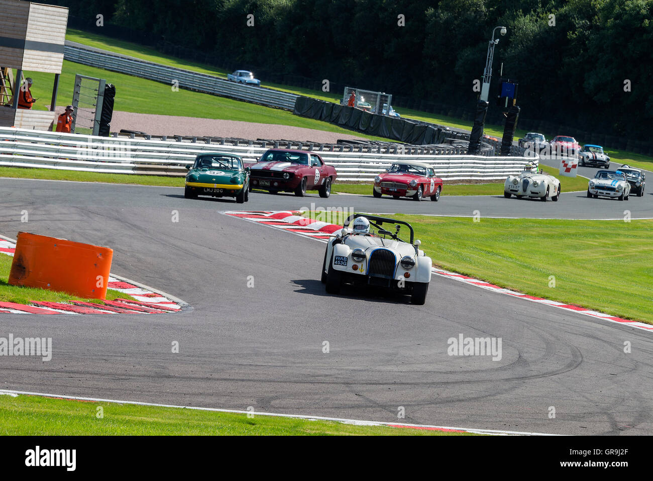 Historic Sports Cars Approaching Brittens Corner at Oulton Park in the Gold Cup Meeting near Tarporley Cheshire England United Kingdom UK Stock Photo