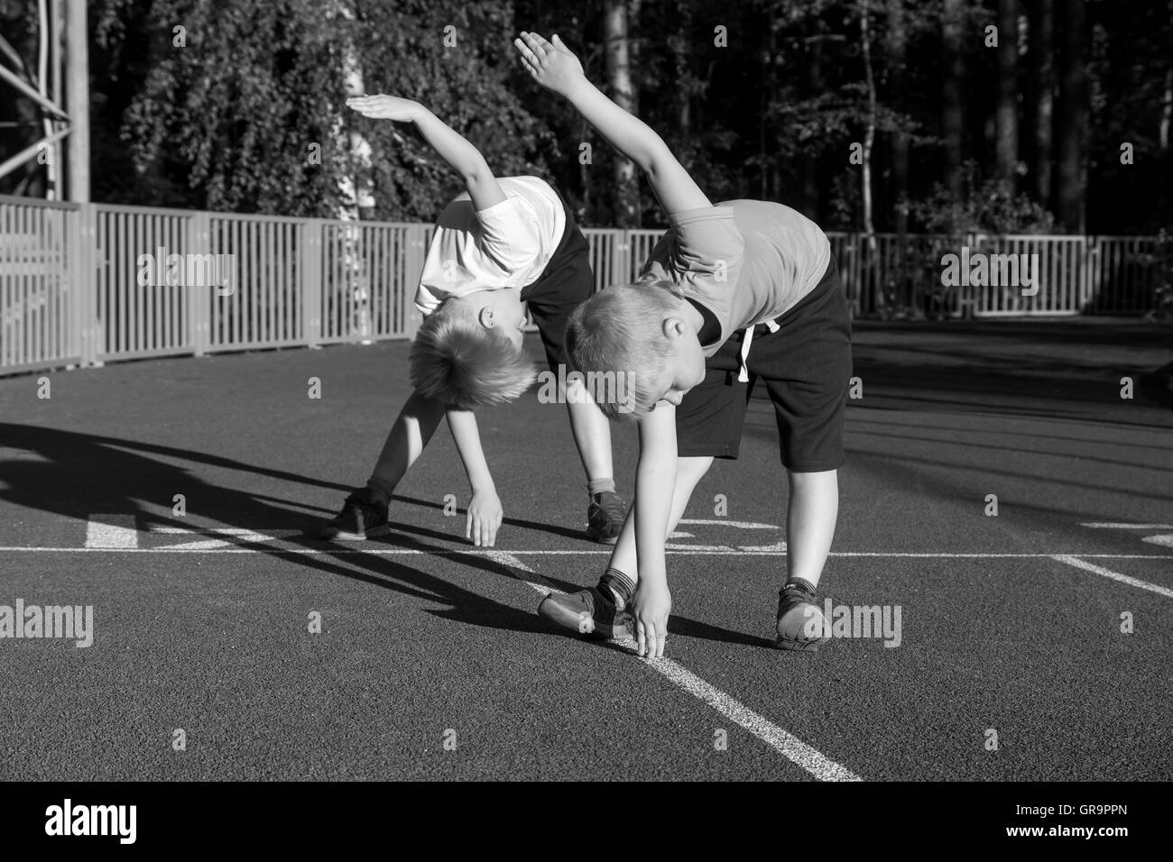 Children doing morning exercises outdoor. Stock Photo