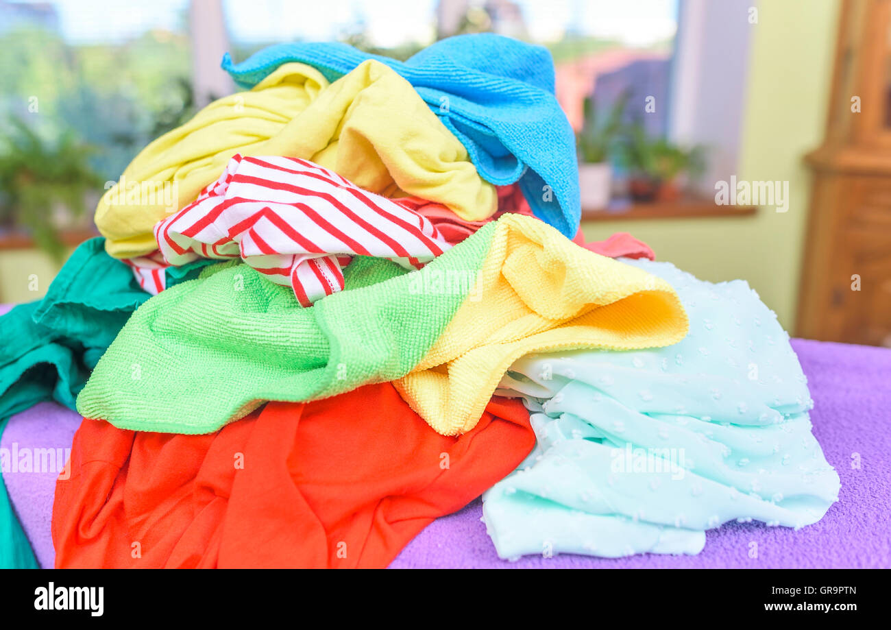 A pile of clothes on the ironing board. Stock Photo