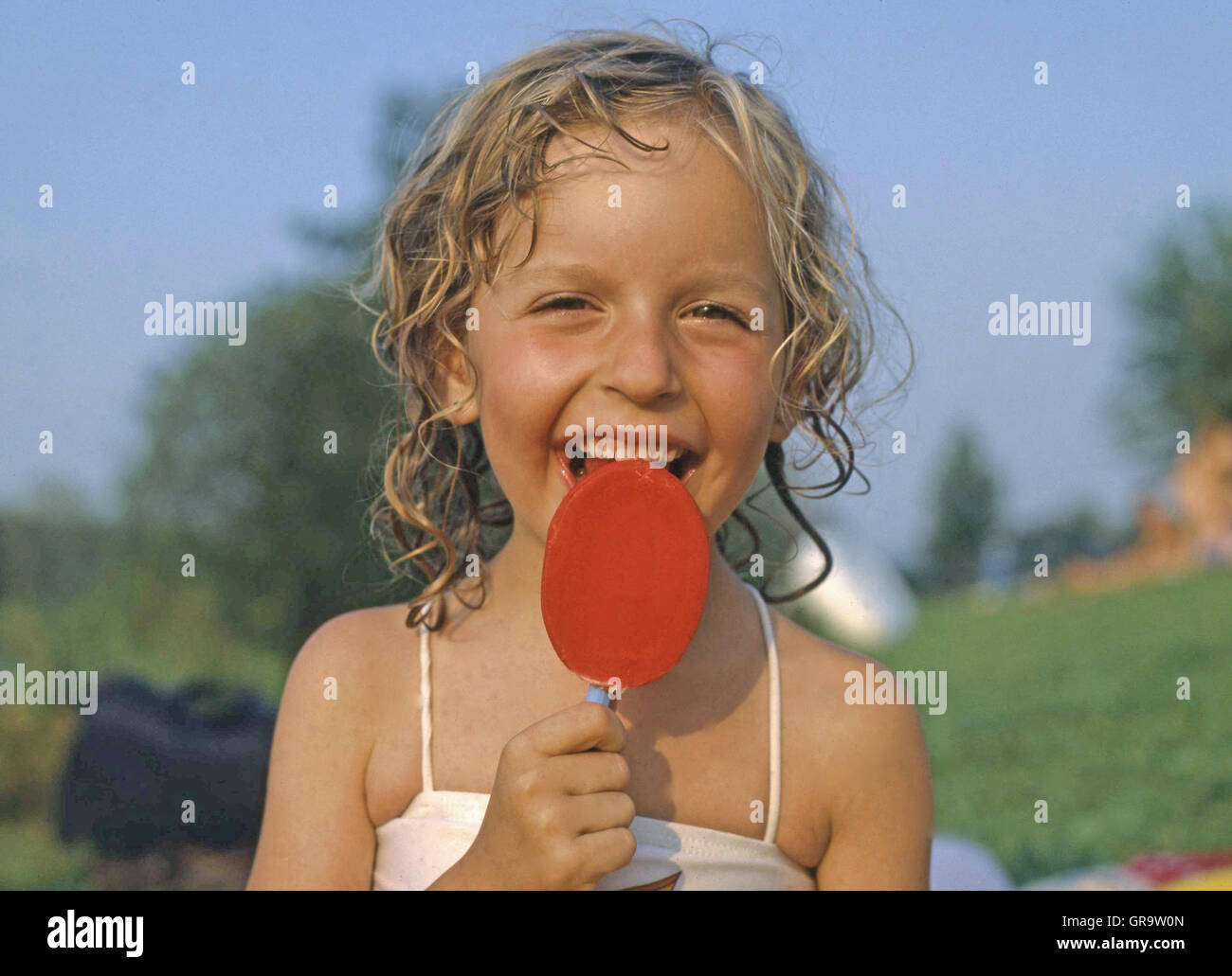 Little Girl Licking Ice Lolly Stock Photo