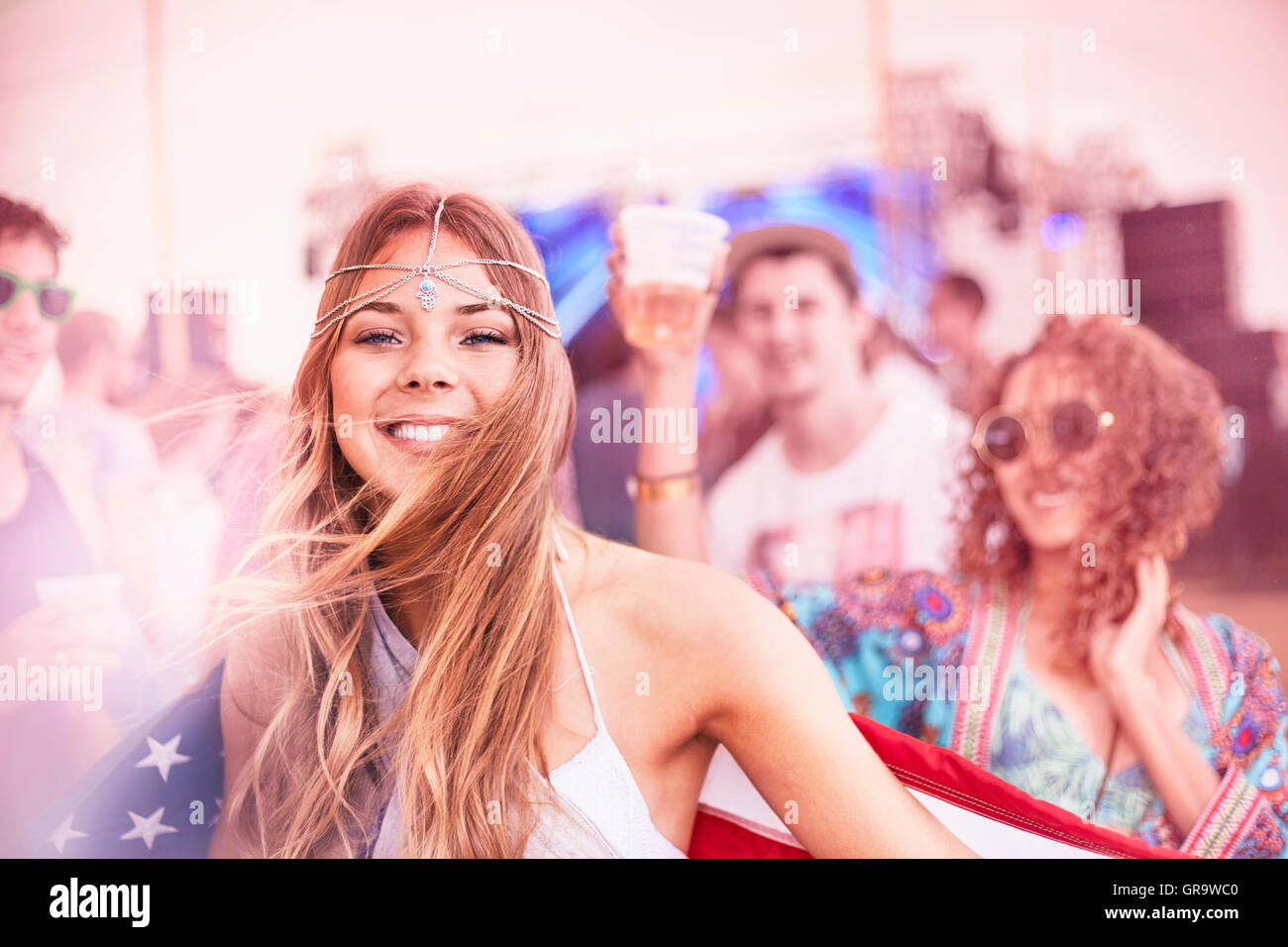 Portrait smiling young woman with American flag at music festival Stock ...