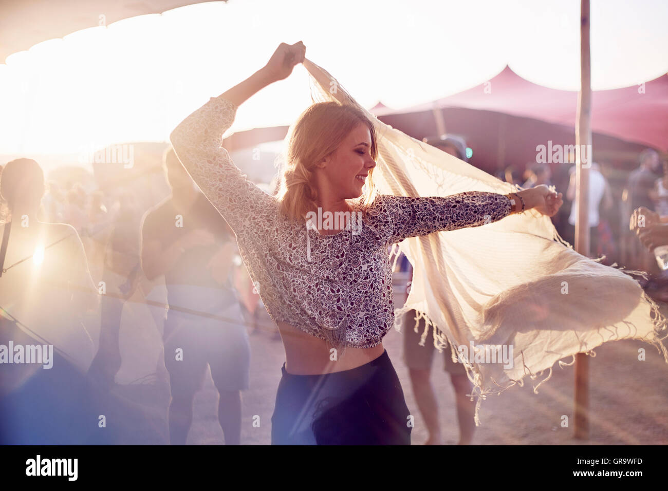 Young woman dancing with scarf at music festival Stock Photo Alamy