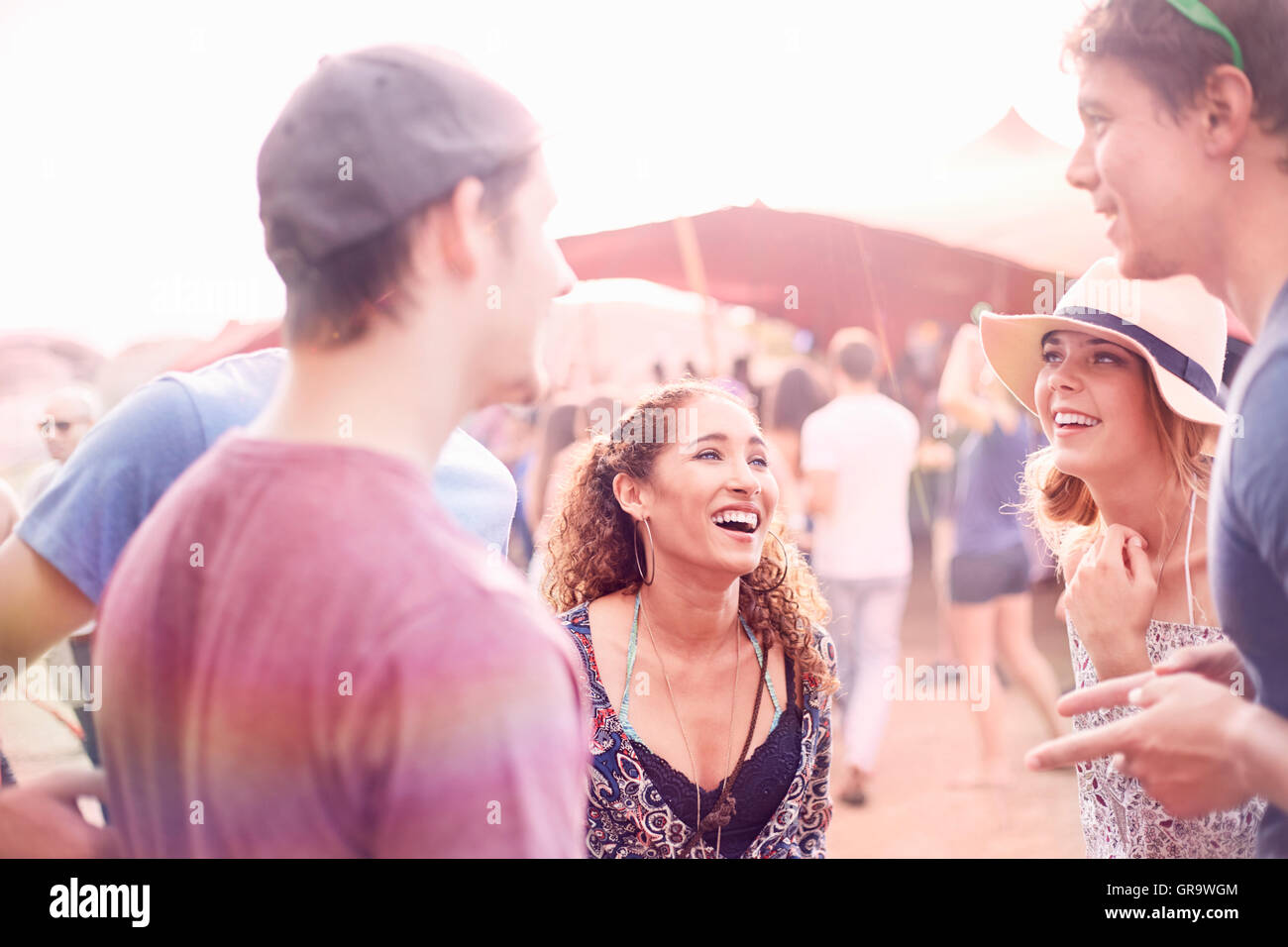 Young friends hanging out talking at music festival Stock Photo