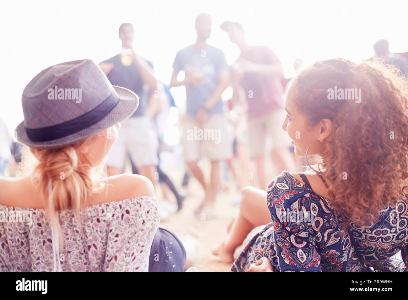 Young women relaxing hanging out at music festival Stock Photo