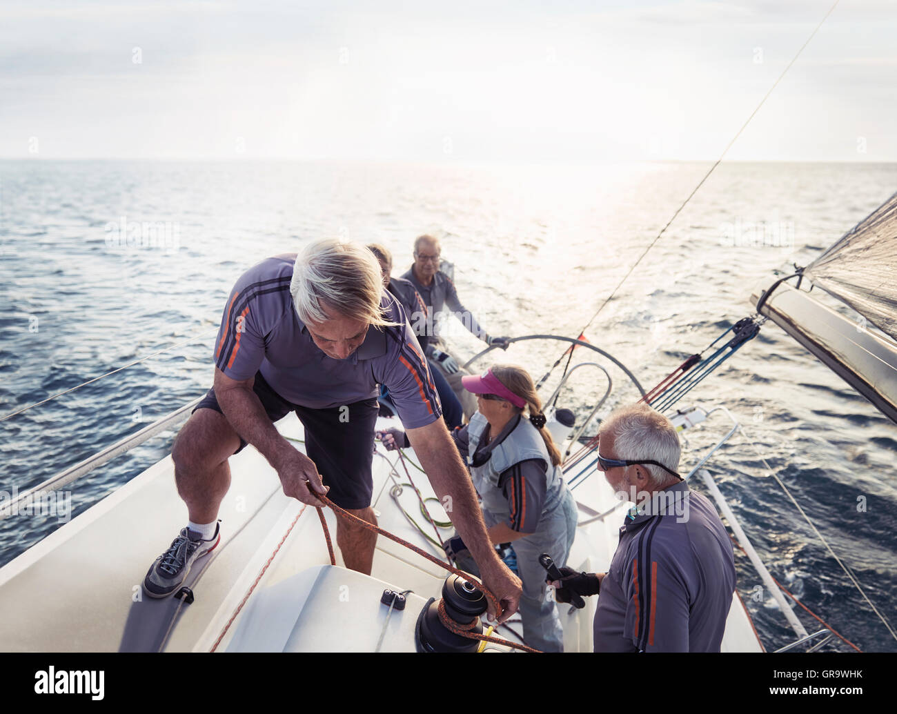 Retired friends sailing on sunny ocean Stock Photo
