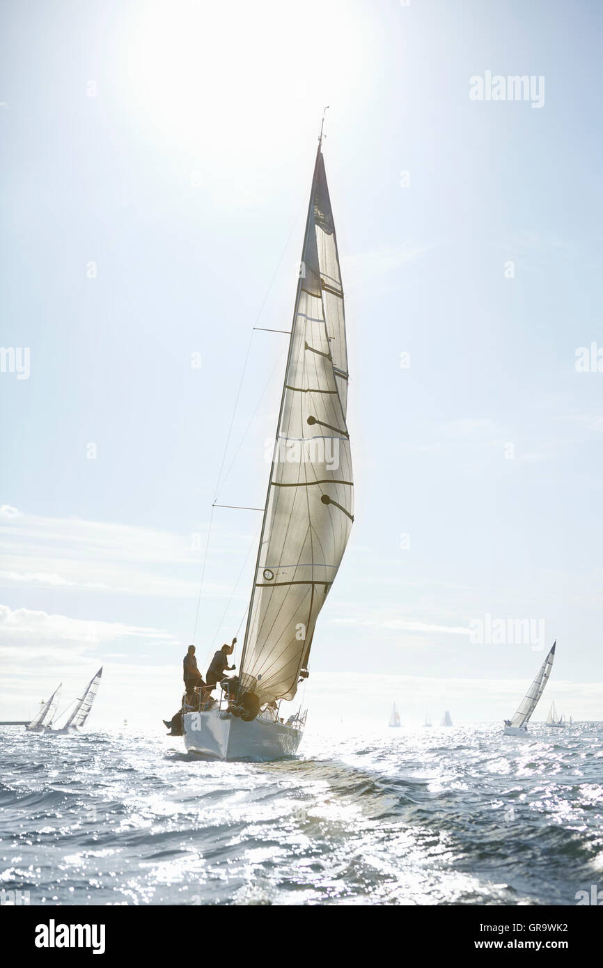Sailboats on sunny ocean Stock Photo