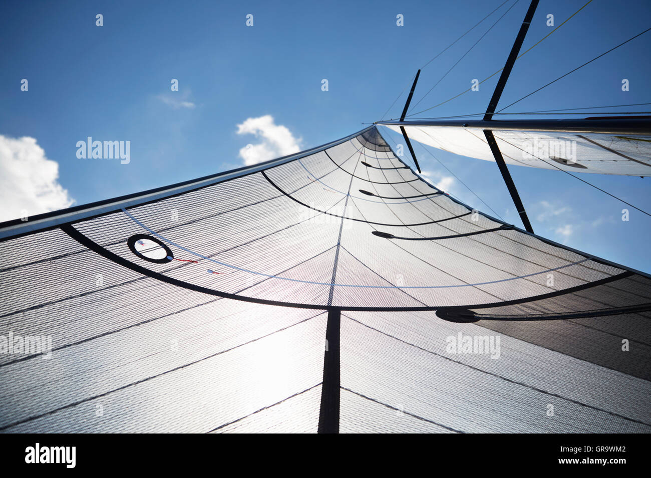 Sailboat sail against sunny sky Stock Photo