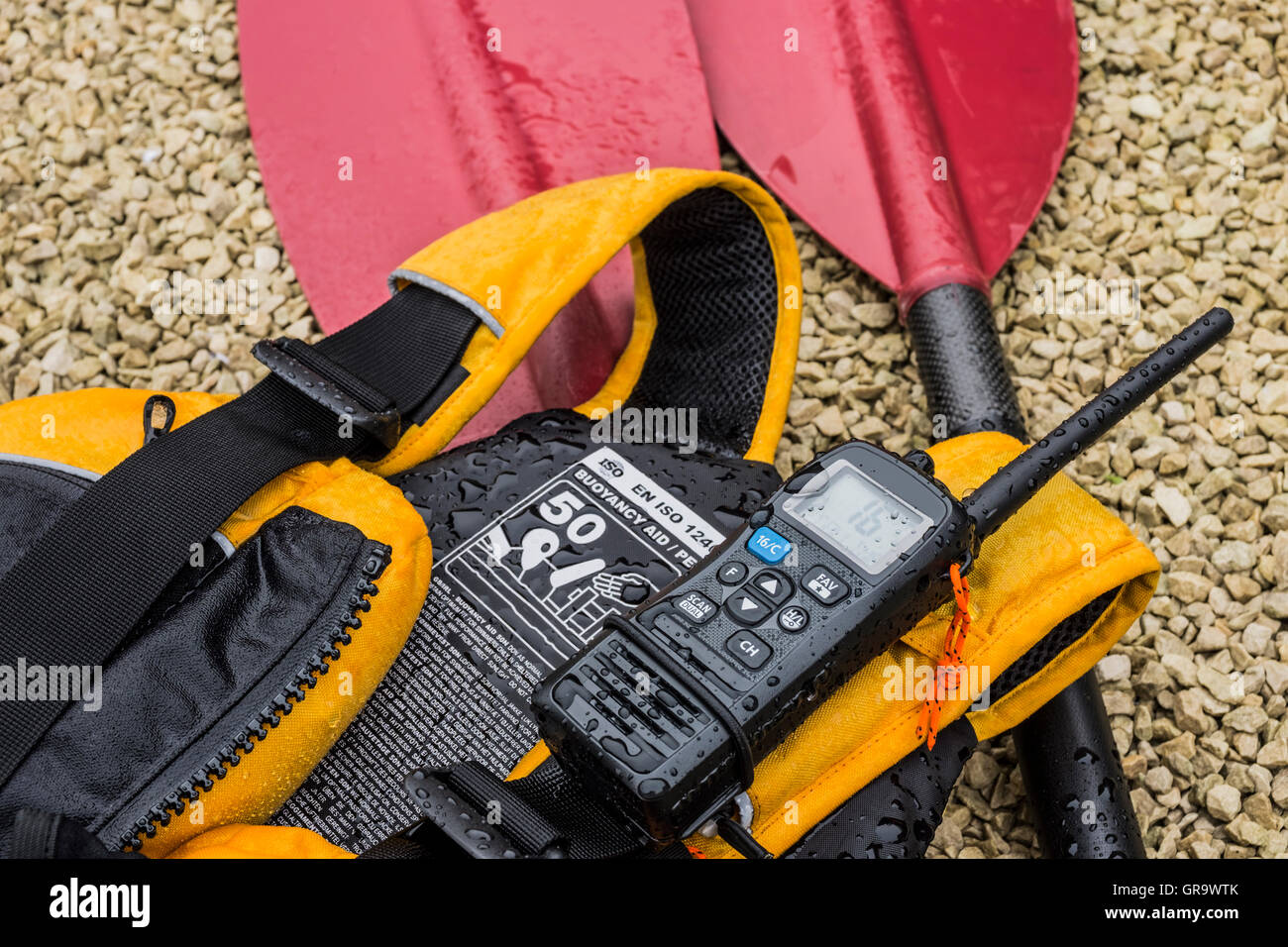 Kayak paddle, buoyancy aid and VHF radio Stock Photo - Alamy