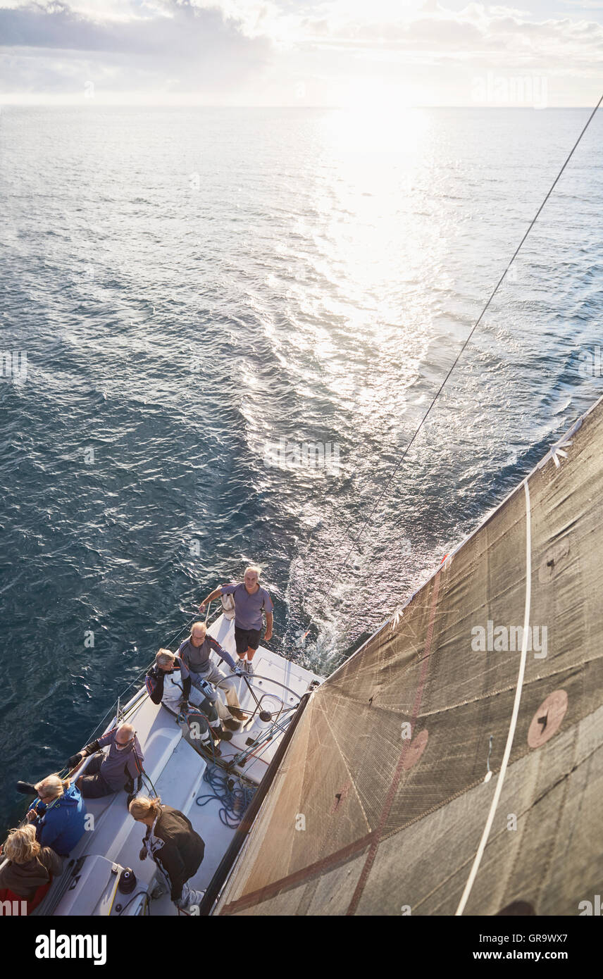 Friends sailing on sailboat on sunny ocean Stock Photo