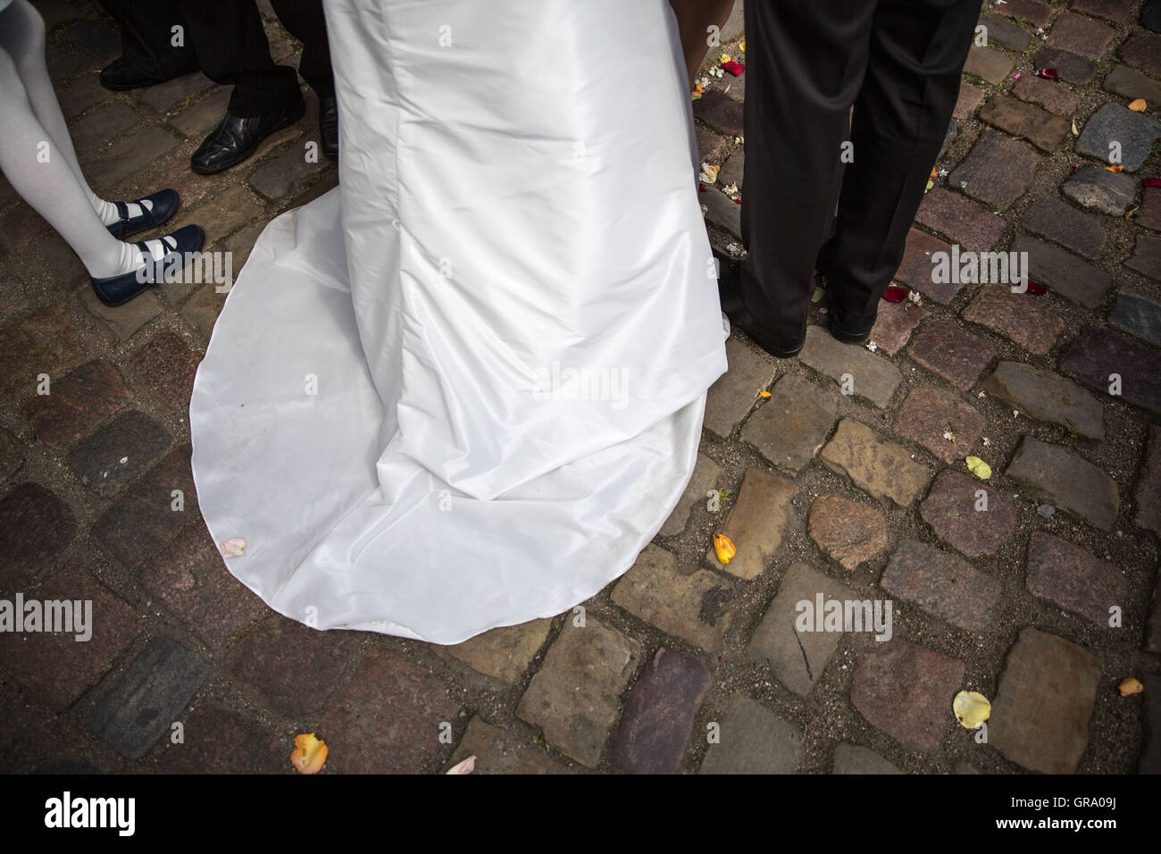 Legs Of Bride And Groom In Front Of The Church Stock Photo