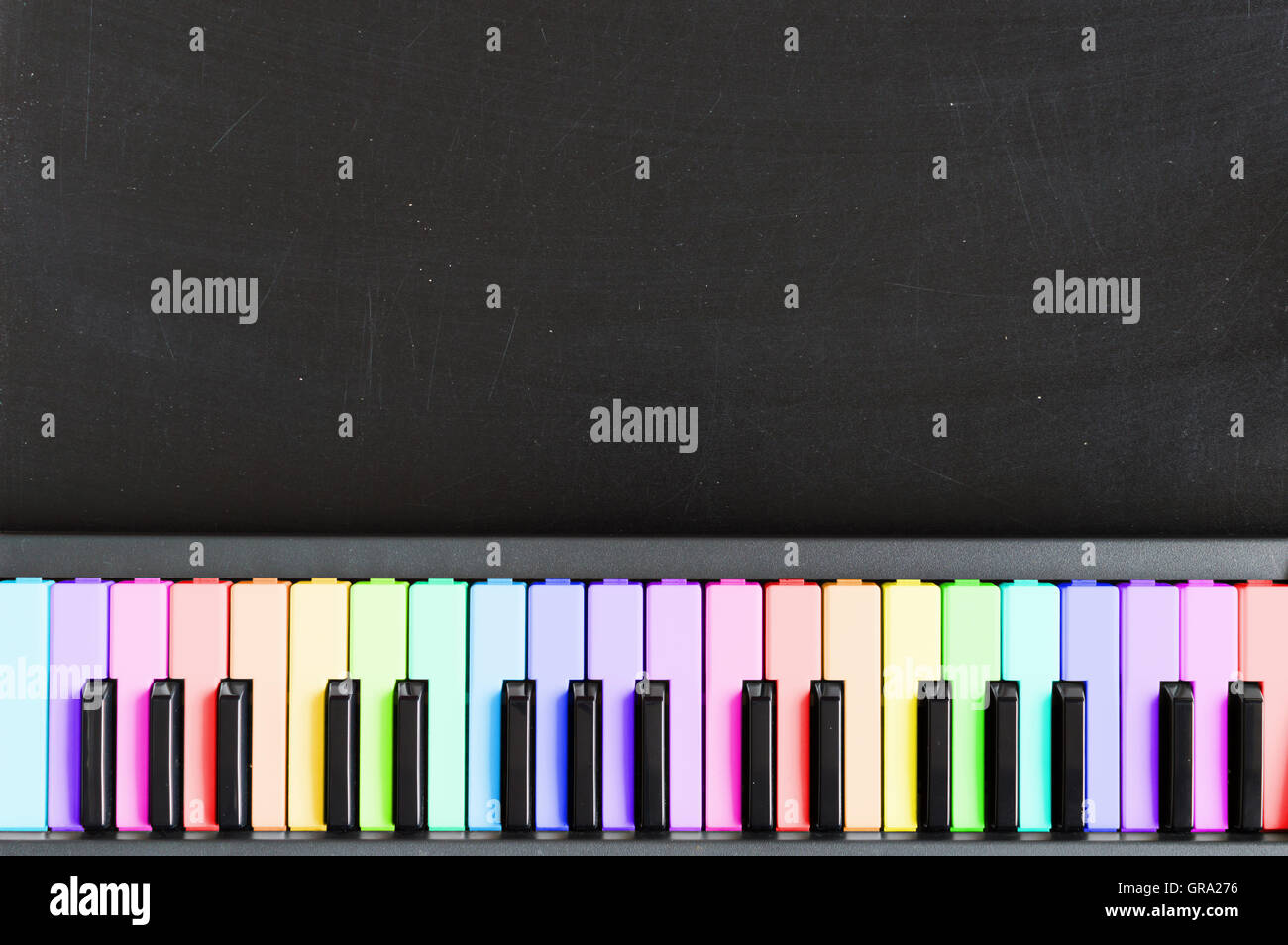 Color Music Keyboard Colorful Music keyboard on blackboard background for music school ...