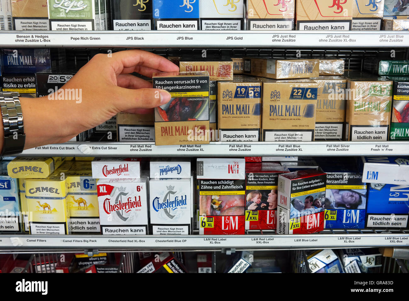Cigarette packings with pictures on cigarette packs to illustrate the dangers of smoking. Stock Photo