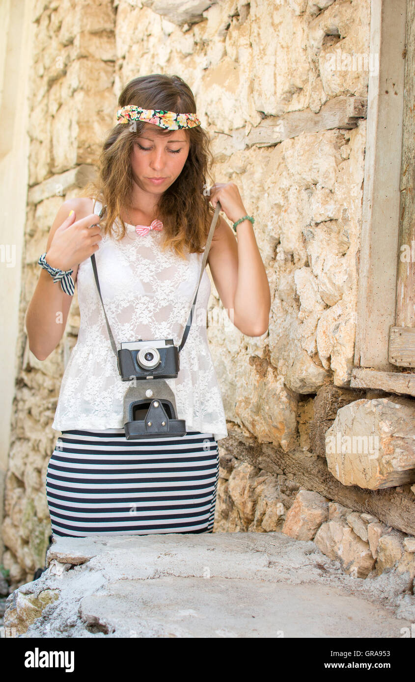 Girl with vintage camera on a old town street Stock Photo