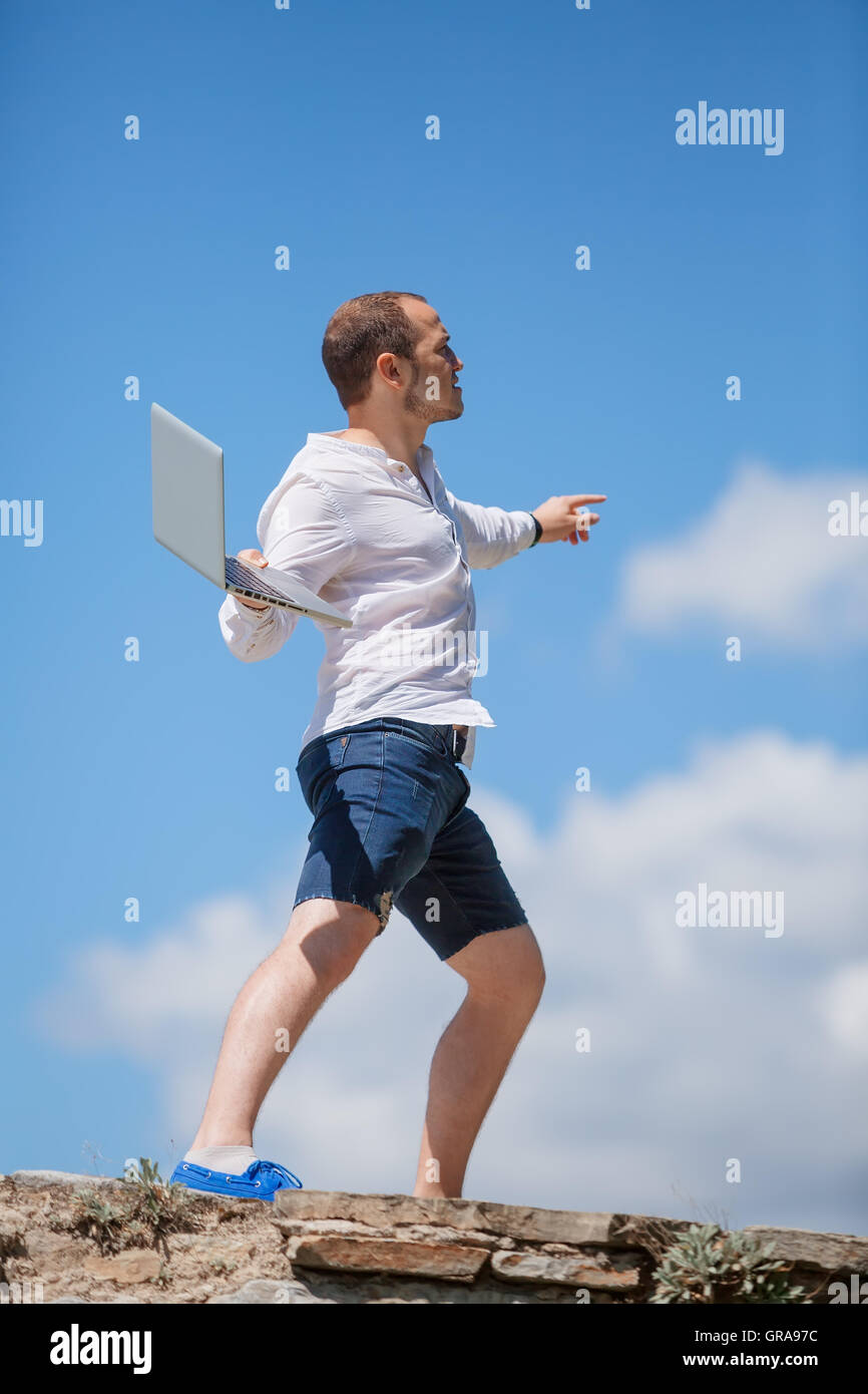 young man throws a laptop Stock Photo Alamy