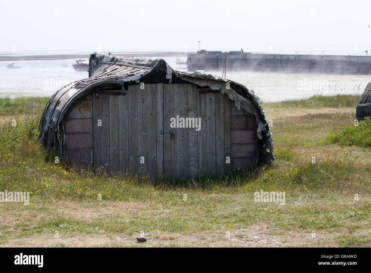 Low tide and morning mist at the harbour on Holy Island,  Northumberland Great Britain Stock Photo