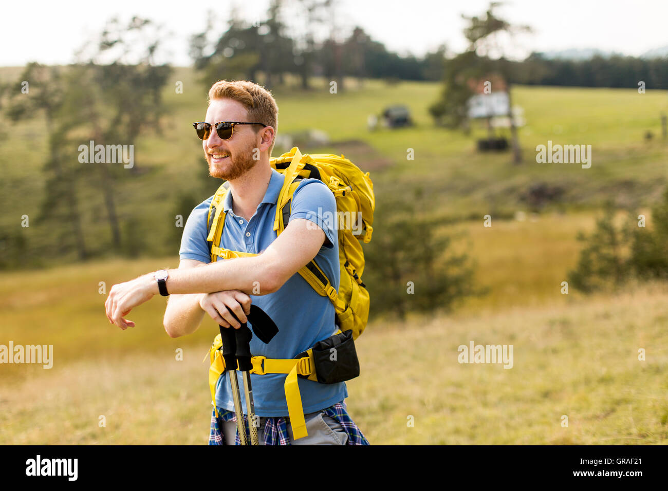 Young backpacking man rest at the hill Stock Photo
