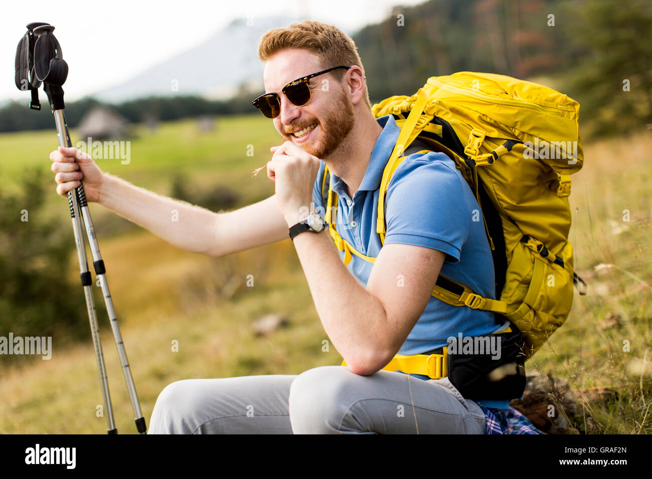 Young backpacking man rest at the hill Stock Photo - Alamy