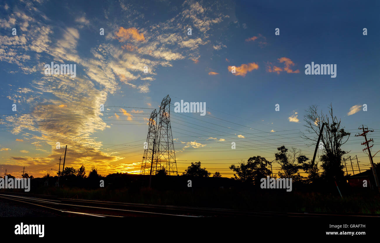 High voltage power pylons in sunset scene twilight Stock Photo - Alamy