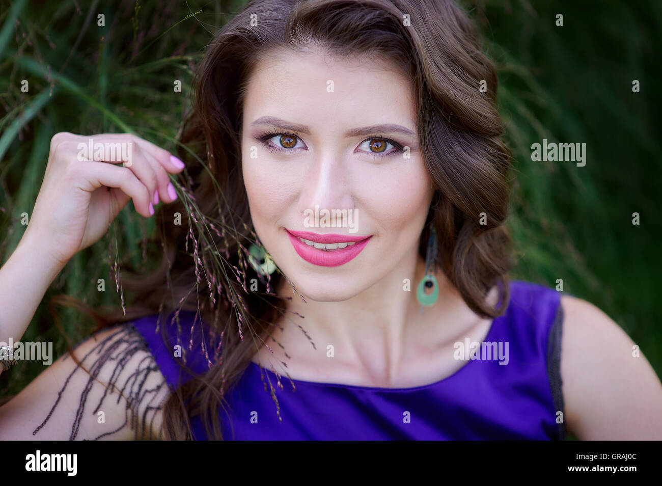 beautiful woman lying on green grass in the park Stock Photo - Alamy