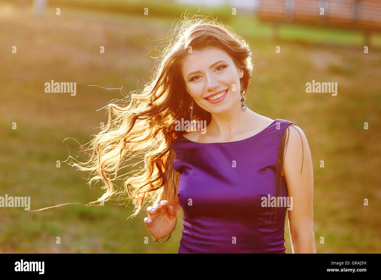 beautiful young woman posing in the park Stock Photo - Alamy