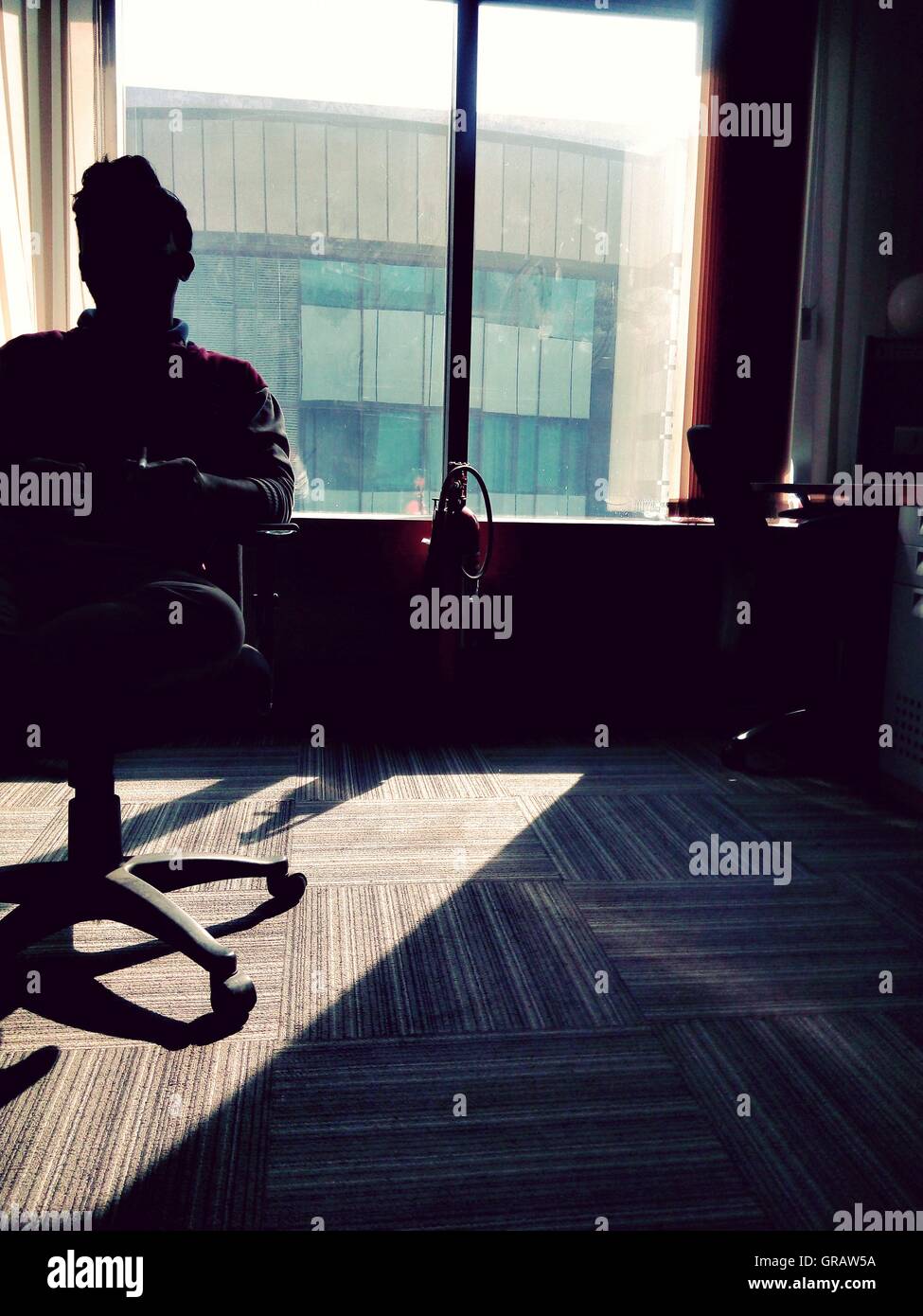 Man Sitting On Chair Against Window At Home Stock Photo Alamy