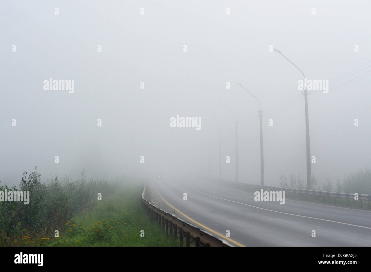 Empty morning road covered with morning fog Stock Photo - Alamy