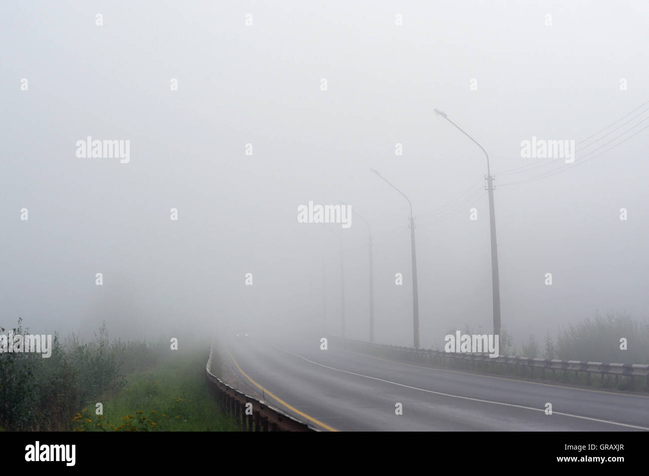 Empty morning road covered with morning fog Stock Photo - Alamy