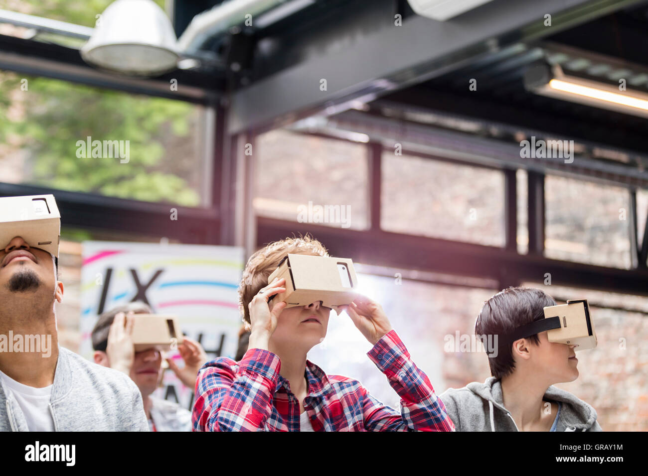 Audience trying virtual reality simulator glasses at technology ...