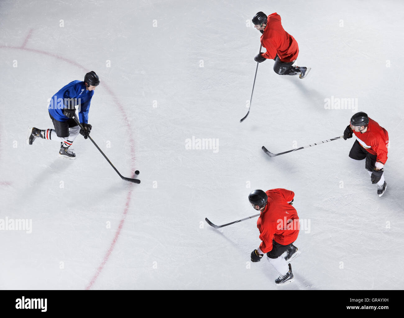 Hockey defenders guarding opponent with puck on ice Stock Photo