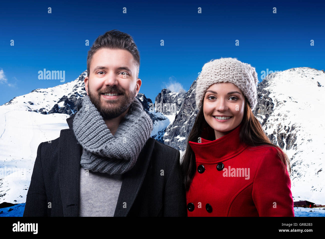 Beautiful young couple in winter clothes in winter mountains Stock ...