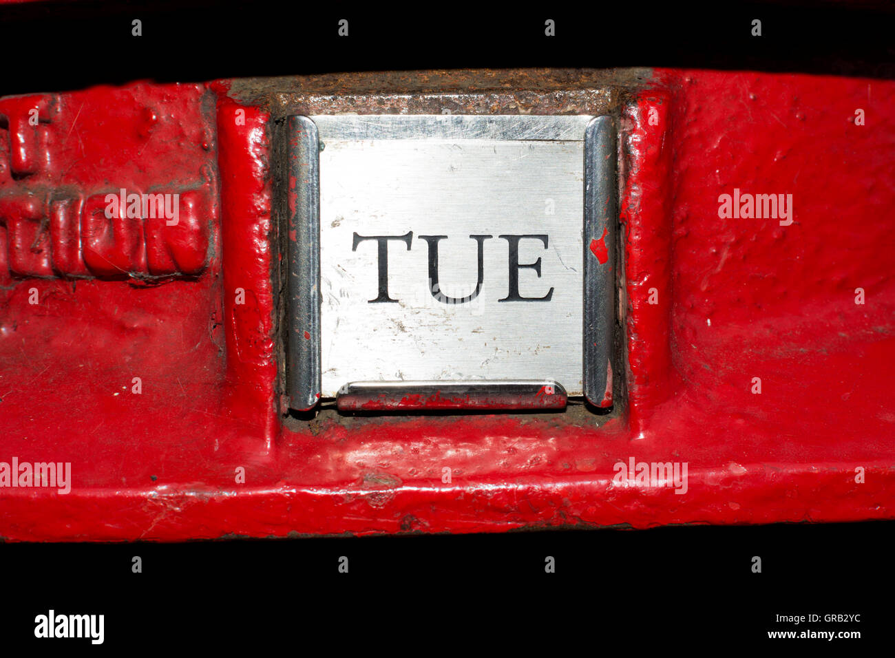 Tuesday next collection plate on red post box, UK Stock Photo