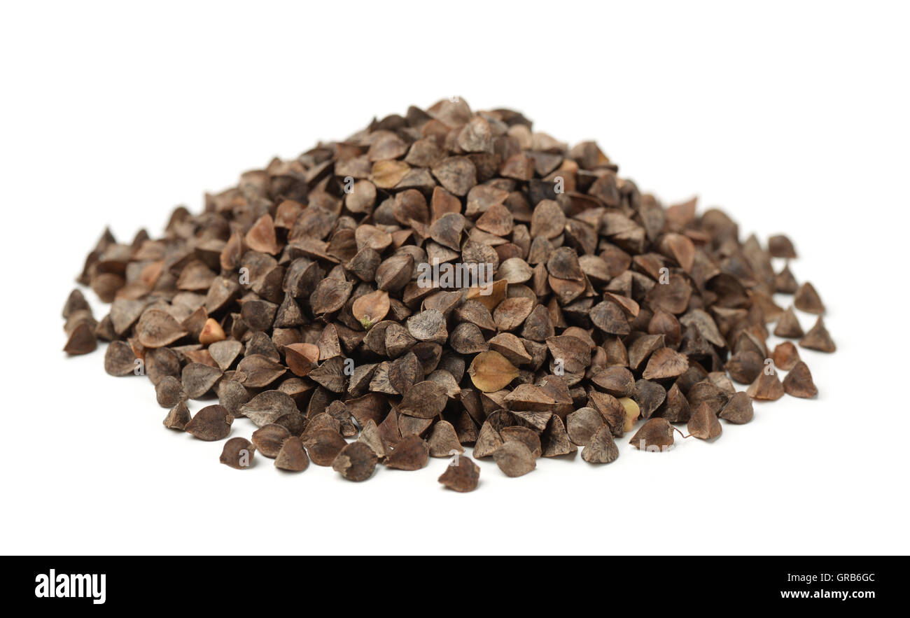 Pile of unhulled buckwheat isolated on white Stock Photo