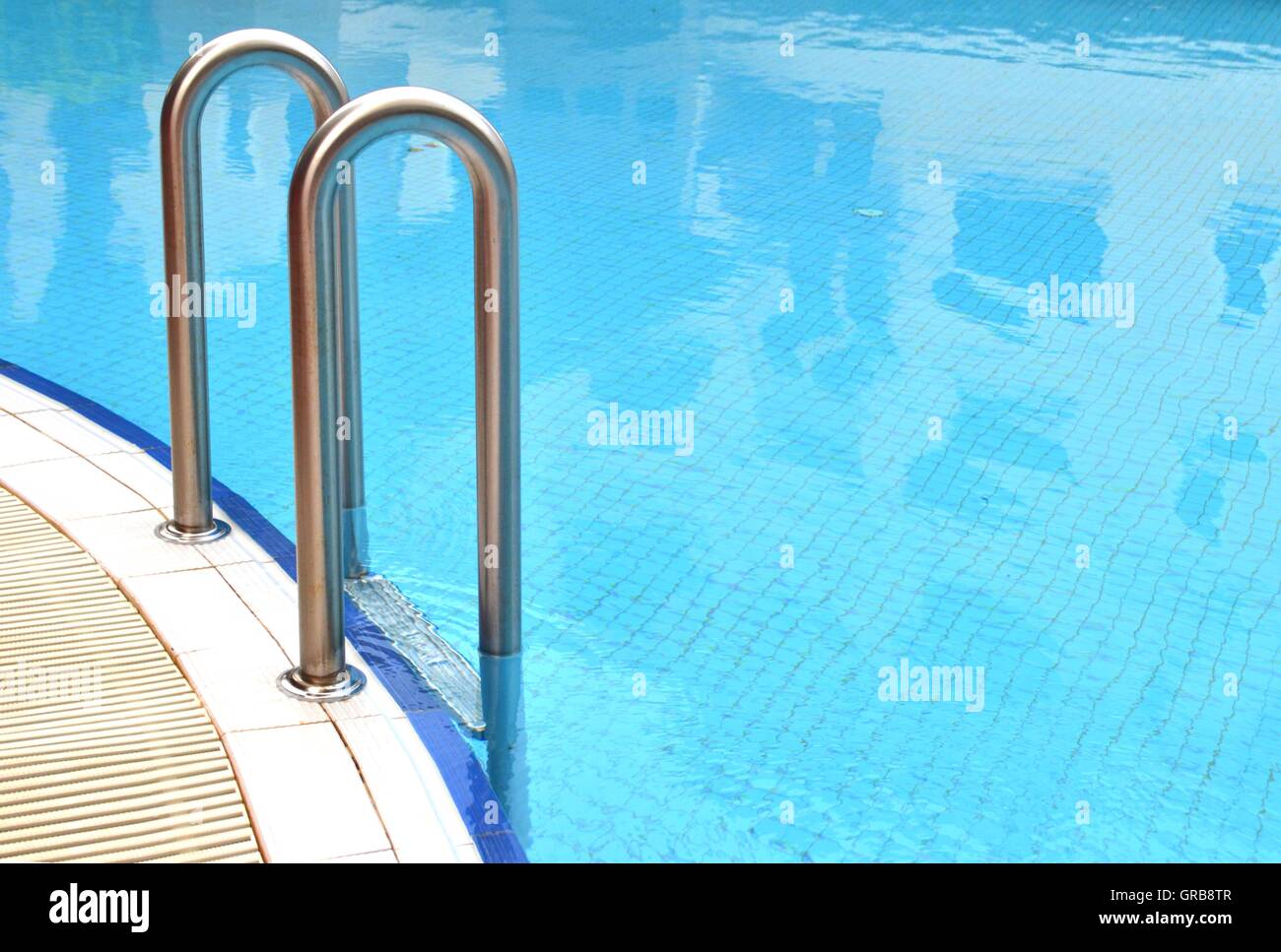 Swimming pool grab bars ladder Stock Photo Alamy