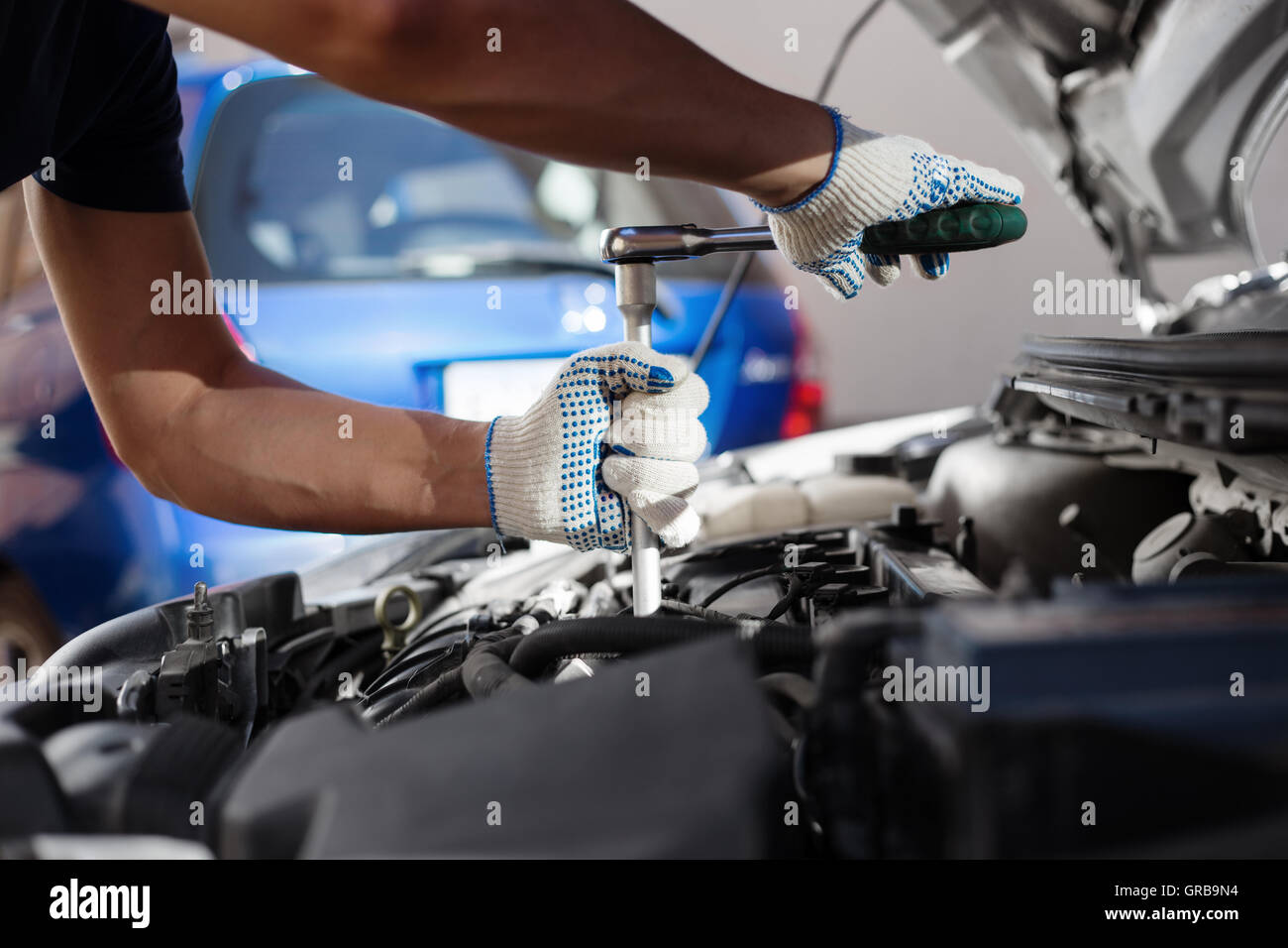 Mechanic working in auto repair garage. Car maintenance Stock Photo - Alamy