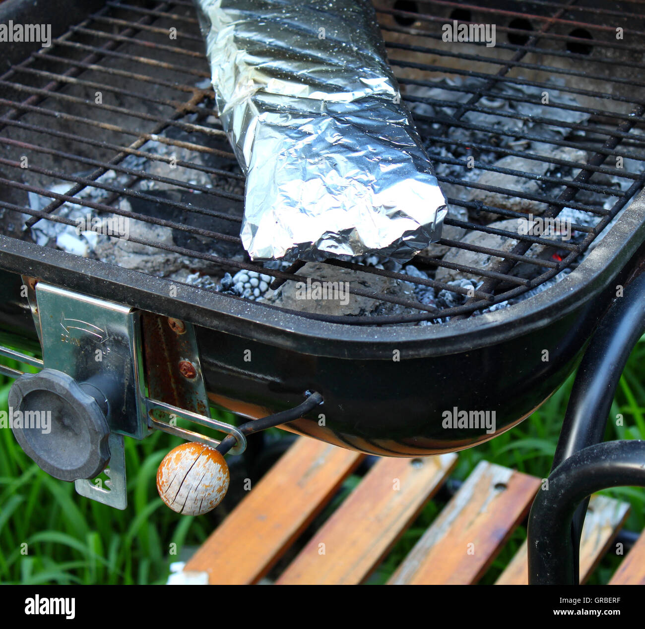 Cooking fish in foil on barbecue Stock Photo Alamy