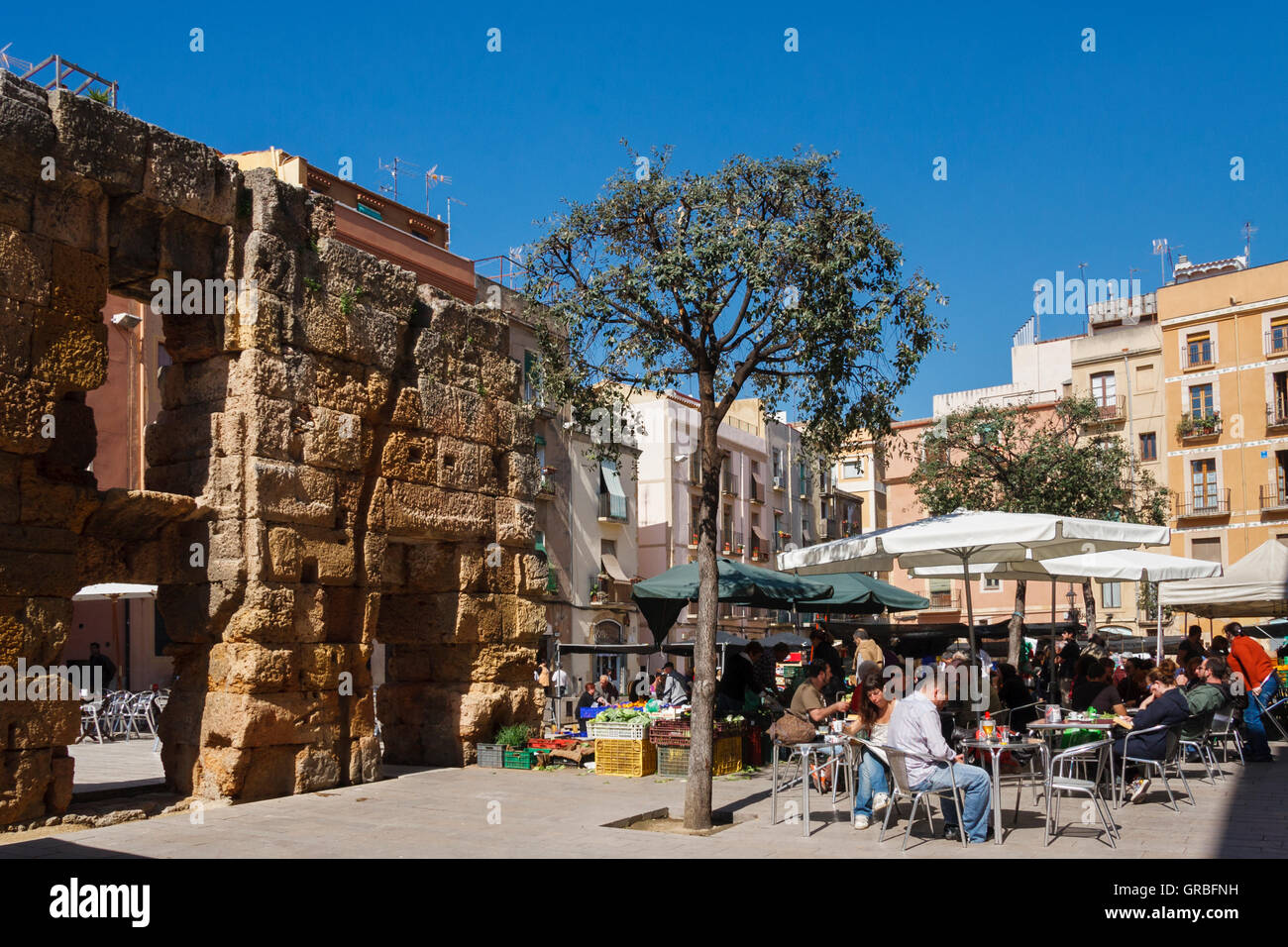 Outdoor market and cafe by roman ruins in la plaza del forum, Tarragona