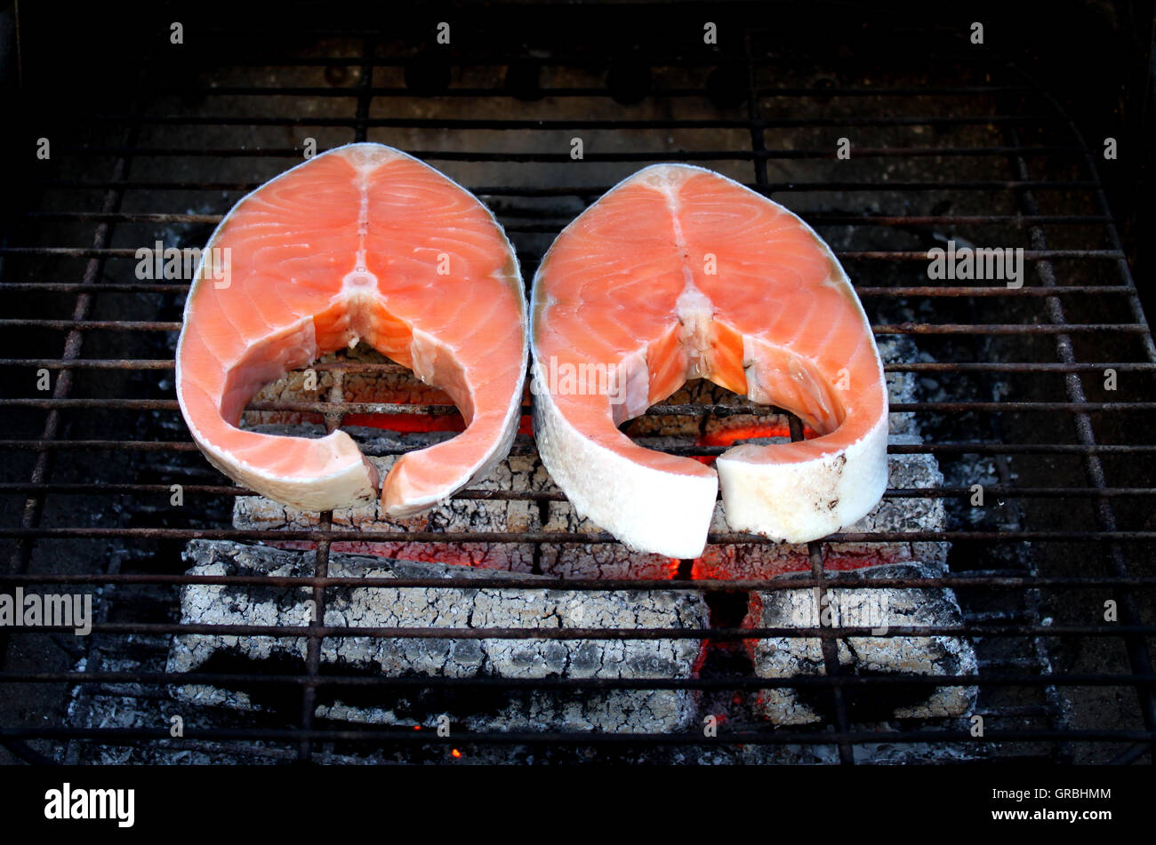 Two fresh salmon steaks on BBQ Stock Photo - Alamy